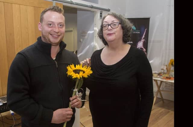 Chris Ledger, CEO of the University of Atypical presents Maghera-based artist Brian Kielt with a sunflower to commemorate being one of the recipients of the individual Disabled/Deaf Artists (iDA) awards.