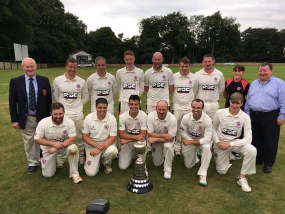 The victorious Templepatrick CC First XI team with scorer Finn Lutton, NCU president Clarence Hiles and Tony Nicholl from Junior Cup sponsors GMcG Chartered Accountants. PICTURE: Duncan Elder