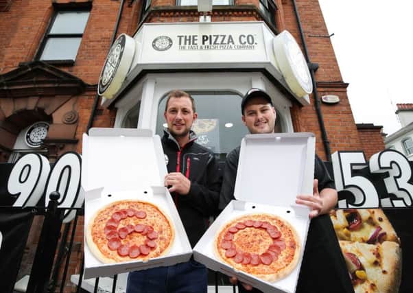 Martin Conlon, co-owner of The Pizza Co and The Chip Co, is pictured with manager of The Pizza Co in Botanic, Matthew Stevenson. Picture by Kelvin Boyes  / Press Eye
