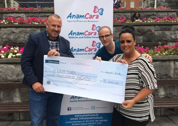 The parents of the late Tiernan Green, Stephen and Donna, hand over a cheque to Anam Cara, a charity which has helped them with their grief since their son's death
