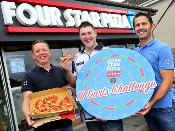 BULLSEYE: World no.5 darts player, Daryl The Superchin Gurney (centre), is joined by Four Star Pizza Directors, Ciaran Bradley and Teague Whoriskey to launch the first ever Four Star Pizza NI Darts Challenge.