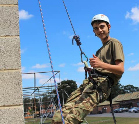 Thumbs up if you love adventure! Feeling on top of the world: 14-year-old Cadet Lance Corporal Connor Oliver from Lisburn.
