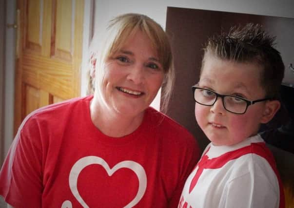 Ballymena woman Mairead Agnew with her young neighbour Mark Lynn who has inspired her to take on the Berlin Marathon on September 16 to raise money for the British Heart Foundation Northern Ireland.