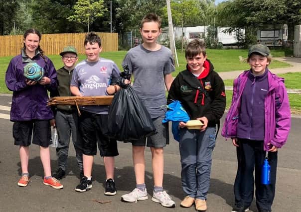 Some of the 5th Ballymena Scout Troop who carried out a litter pick while canoeing at a recent weekend sponsored camp pictured with some of the rubbish they collected.