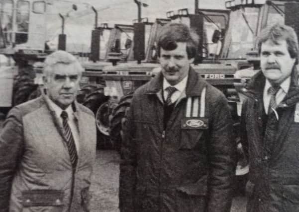 Wilbert Kenny, sales manager of Agricultural Department of R Kennedy and Company with sales executives, John McAllister and Johnathan Aiken. 1989.