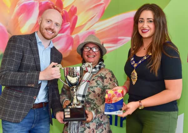 Kimanh Nguyen won Best in Show and Best Monster Vegetable for her trombone courgette at the Mid & East Antrim Flower Show pictured receiving her prize from the BBC's Barra Best and the Mayor Cllr Lindsay Millar. Submitted Pictures.