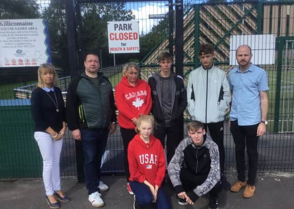 DUP Cllrs Margaret Tinsley and Darryn Causby with Keith McCann Chairman of Killicomaine Residents Group and young people who use the MUGA pitch at Killicomaine which has been closed due to vandalism
