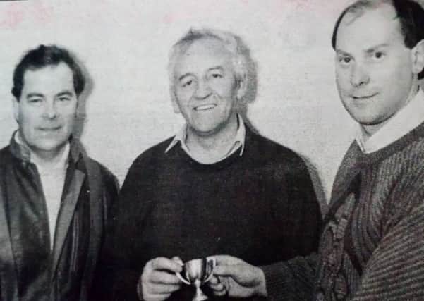 Bertie Armstrong receives his replica cup to commemorate the 3-2 win over Ballymoney United in the O'Gorman Cup final - 28 years before! from Alistair Robinson while (left) Colin Rostron junior looks on.