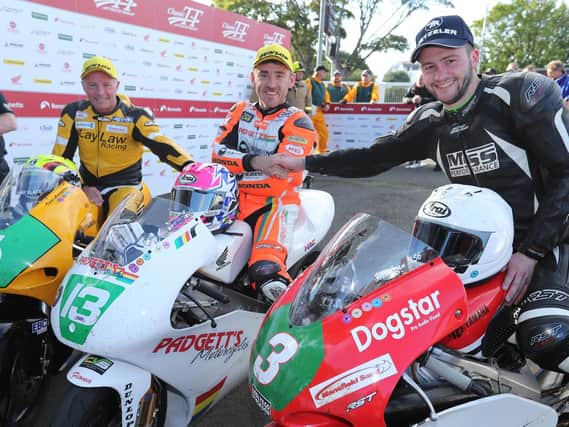 Lee Johnston (centre) celebrates winning the Dunlop Lightweight race at the Classic TT from runner-up Adam McLean (right) and Ian Lougher.