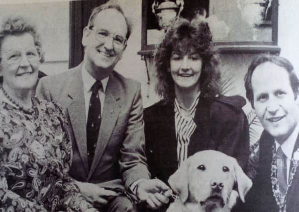 Helping the Mayor, Councillor Winston Fulton, to launch the Mayor's Appeal for Guide Dogs for the Blind in Larne is Niven, the four-year-old labrador. Looking on is Deputy Mayor Rachel Rea and appeal organisers Bertie Dodds and Julie Millar. 1989.