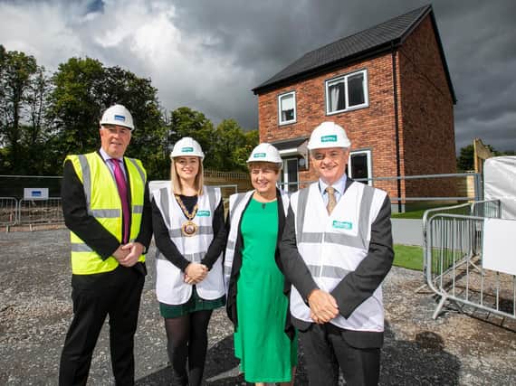 Eugene Lynch, Managing Director of The McAvoy Group, Cllr Cheryl Johnston, Deputy Mayor for Mid and East Antirm, Clare McCarty, Group Chief Executive at Clanmil Housing and David Orr, Chief Executive of the National Housing Federation in front of a prototype house at Clanmil's site in Carrickfergus, where 40 new social homes will be the first in Northern Ireland delivered using off-site construction.