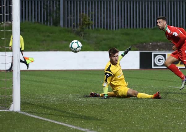 Cliftonville's Joe Gormley scores a goal past Lisburn Distillery goalkeeper Jonah Nicholl
