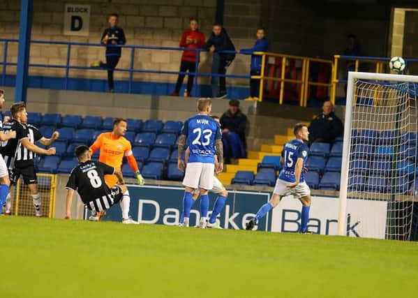 Dergview's  Mathew Callaghan scores the only goal of the game against Glenavon