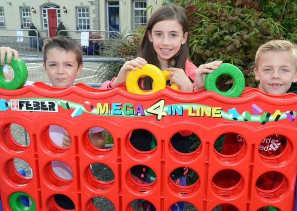 Making connections at the annual Richhill Village Fete last year are from left, Ben Murnion (10), Rebecca Kenny (10) and Thomas Kenny (8). INPT37-204.
