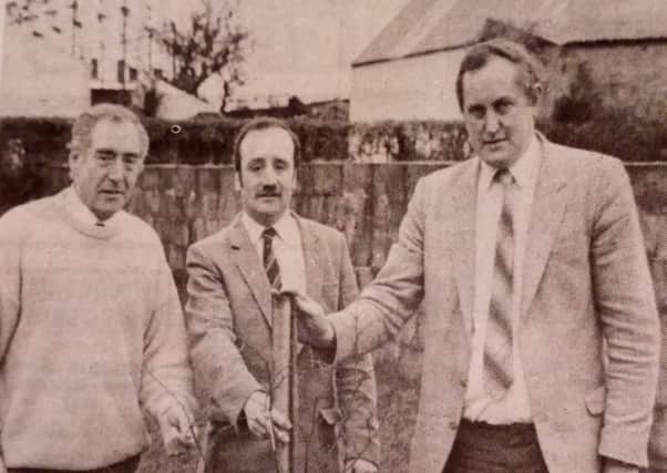 Councillor Desmond Armstrong (right) who is the first to sponsor a tree in the Broughshand Village Improvements Committee tree planting campaign. Included are committee members, William Campbell (left) and David Cupples. 1989.