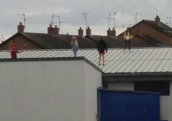 Youths on the roof of the former Lidl building in Lurgan