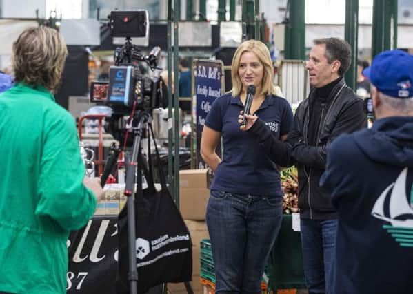 'Travel Guy'  Jim Gordon interviewing Caroline Wilson from Belfast Food Tour during filming in St George's Market, Belfast.