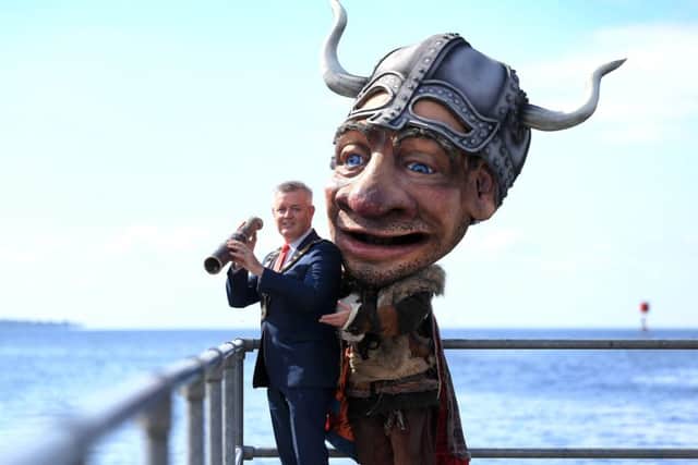 The Mayor Councillor Paul Michael looks over at the site of the new Lough Neagh Gateway Centre at Antrim Loughshore Park with Vinnie the Viking.