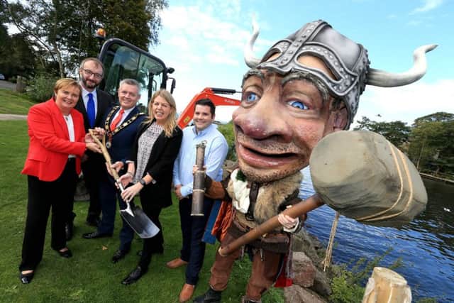 The Mayor Councillor Paul Michael officially cuts the sod of the new Lough Neagh Gateway Centre at Antrim Loughshore Park with Jacqui Dixon (Chief Executive, Antrim and Newtownabbey Borough Council), Dr William Burke (Landscape Partnership Manager), Fiona McCandless (DAERA), Sean Rock (Lough Neagh Rescue Chairman) and Vinnie the Viking.