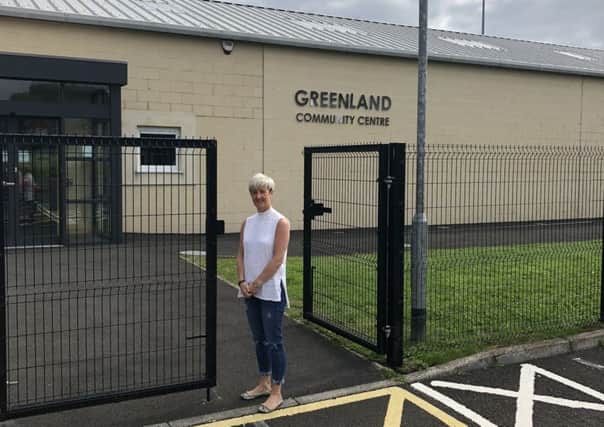 Cllr Angela Smyth at the newly erected fence at Greenland Community Centre.