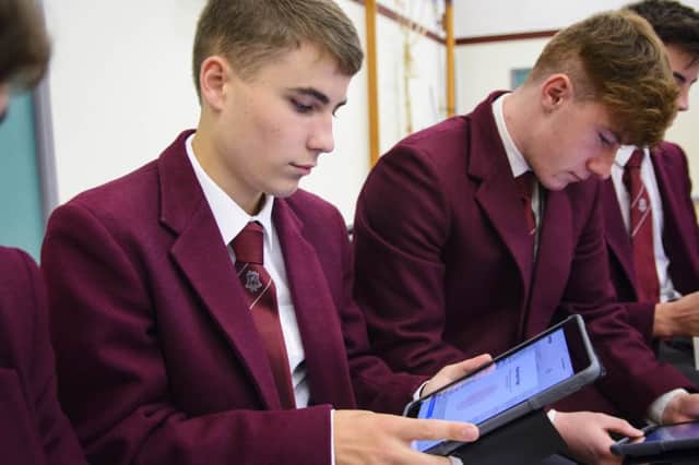 Sixth form pupils woking on their new devices.