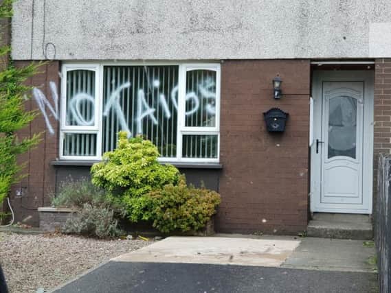 Sectarian graffiti sprayed on front window
