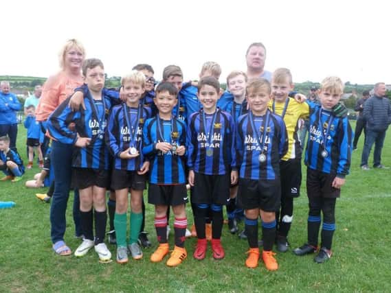 One of the Whitehead teams proudly show off their medals.