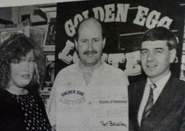 Winner of the Golden Egg Lottery is Tracy Poland who is pictured being presented with her cheque for Â£1,000 by Pat Bradley (left), lottery promoter and (centre) Eugene Diamond, owner of 'Sweet Sensation' where Tracey bought her winning ticket. 1989.