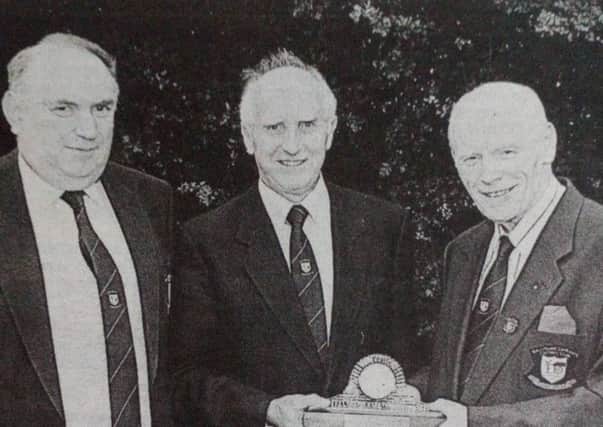 Ballyclare Comrades Chairman George Herron  presents George Brown with a crystal clock to mark his 1,000 match reporting on the Comrades over the last 25 years. Looking on is Eddie McClintock. 1997.