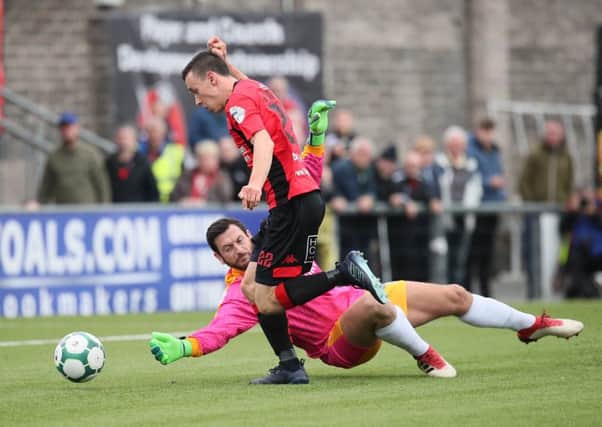 Crusaders' Paul Heatley rounds Newry's Andrew Coleman to score during Saturday's game at Seaview.  Photo by David Maginnis/Pacemaker Press