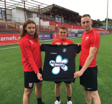 Ben Tinley, Matty Henry and Paul Finnegan displaying Larne's support for the charity.