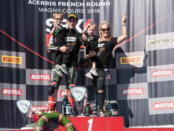 Four-time World Superbike champion Jonathan Rea celebrates with his wife Tatia and children, Jake and Tyler on the podium at Magny-Cours in France.