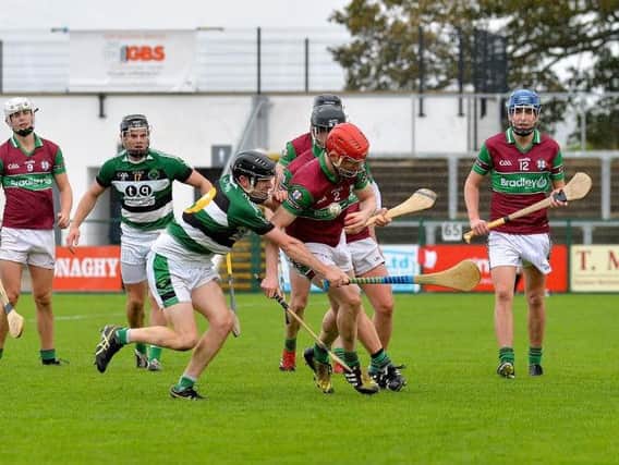 Na Maghas Mark McCloskey and Eoghan Ruas Colm McGoldrick battle for during the Junior Hurling Championship Final at Owenbeg on Sunday afternoon last. DER3918GS072