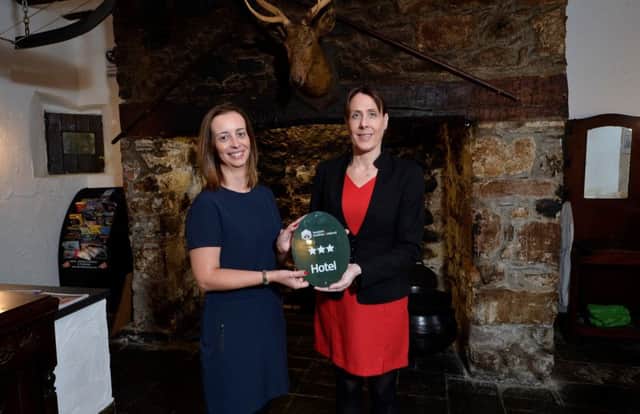 Cathy McCormick (left), Quality & Standards Schemes co-ordinator at Tourism NI, presents the three star grading plaque to Kirsty Fallis,  manager, Dobbins Inn Hotel.