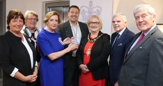 Mrs Alison Millar Lord-Lieutenant of County Londonderry and Cllr Brenda Chivers Mayor of Causeway coast and Glens Borough Council congratulate Mr Ricky Wright from the Vineyard Compassion group in Coleraine after they were officially presented with the
Queen's Award for Voluntary Service AS Lorraine Young DL, Lady Girvan MBE DL, Dr Bill McGinnis CBE,DL, and Desmond Hill DLl ook on.PICTURE KEVIN MCAULEY/MCAULEY MULTIMEDIA
