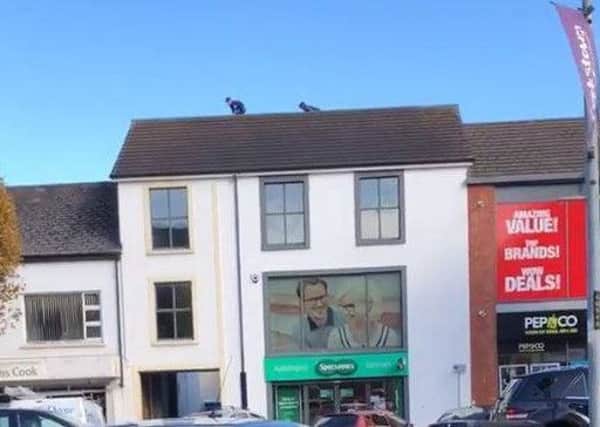 Kids on the roof above shops in Cookstown