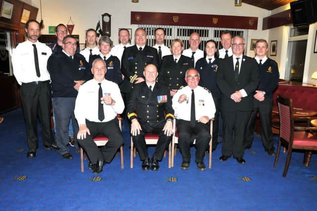 Peter Mizen, Head of the Coastguard  Coastal Operations, presents long service medals to Clifford Kerr and KennyMcDowell, who have both served 40-plus years with Portmuck Coastguard. at a reception held in Larne Golf Club. INLT 39-202-AM