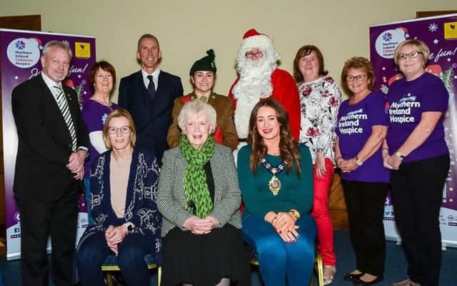 Pictured at the launch are Bill Crymble (left), director of Forever Living Products Ireland, Jingle All The Way campaign sponsor; John Madden (back third from left), principal of Roddensvale School, who compered the morning event; Cllr Maureen Morrow (back, third from right) and members of the Larne NI Hospice Support Group.  The Mayor, Cllr Lindsay Millar, who hosted the launch, is seated with Mrs Joan Christie CVO, OBE and Alison McClean, Events & Marketing manager, Forever Living Products.