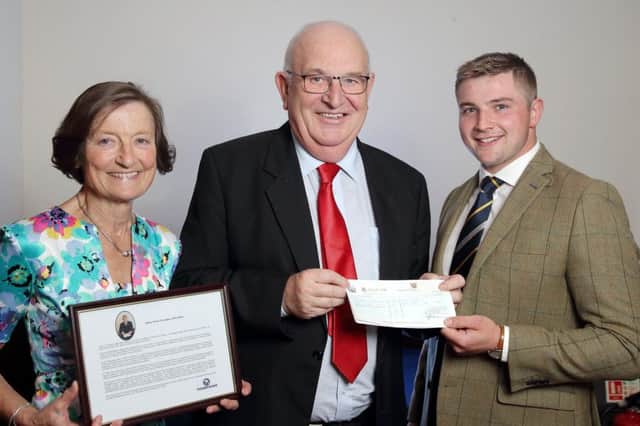 Mrs Ann Davey and George Starrett, from John Thompson, presenting the Victor Truesdale prize cheque to Lewis McClinton. Picture: Cliff Donaldson