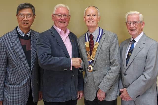 Coleraine Probus Club President Des Moore greets Ken Ward, with club member John Tan (L) and club Treasurer Nigel Semple (R). Ken spoke to members about '50 Years of The New University of Ulster'.