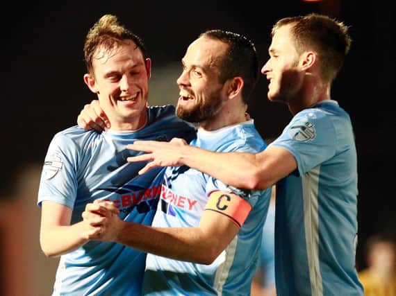 Ballymena United's first scorer Reece Glendinning celebrates with Tony Kane and Conor Quigley.