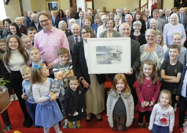 The congregation of Cairncastle Presbyterian presenting Rev Fiona Forbes with a painting of the local area.