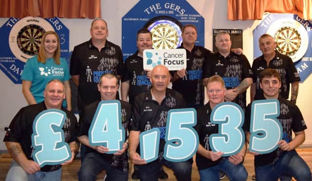 Louise Greer, Corporate Fundraising officer at Cancer Focus NI, with members of Gers Dart Club.