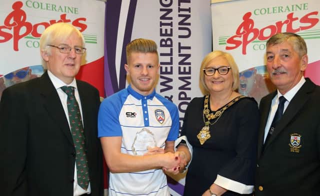 Lyndon Kane accepts the Senior Sports Team of the Year award on behalf of Coleraine FC from the Mayor of Causeway Coast and Glens Borough Council Councillor Brenda Chivers with Robert McVeigh from Northern Ireland Commonwealth Games Council and John Church, Chair Coleraine Sports Council.