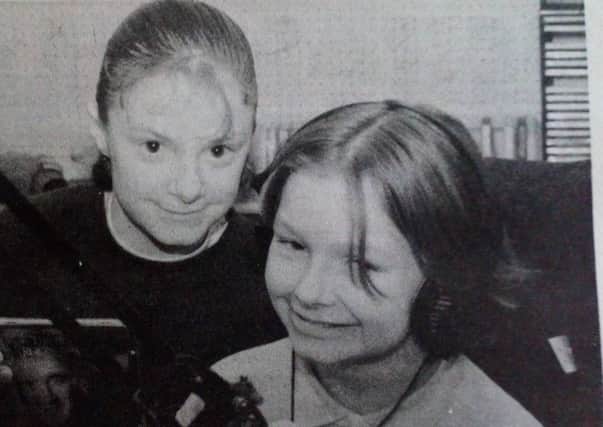 Junior YFC members Wendy Stitt and Louise Crawford (right) of  get some experience behind the microphone during their visit to Moyle Radio. 1991.