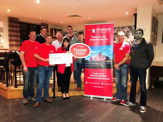 Broughshane Dairy Farmers' Development Group Secretary, William Adams and some of the Committee members handing the cheque for Â£5000 to
Michelle from the Northern Ireland Air Ambulance Charity.