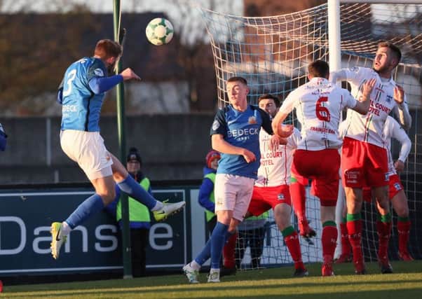 Dylan King attacks a corner-kick delivery for Glenavon against Newry City AFC. Pic by Pacemaker.