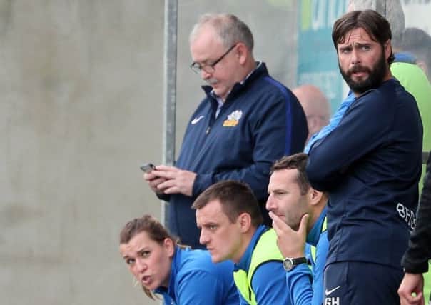 Glenavon manager Gary Hamilton (right) sharing the dugout with part of the backroom team.