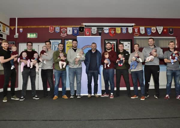 Greenisland FC manager Stuart McClean with players and babies.