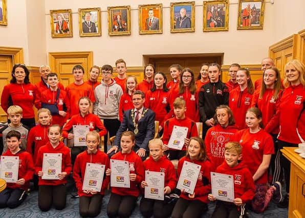 Junior members of the City of Derry Spartans and coaches Bridgeen Byrne and Martina McCafferty pictured at the launch of the new Athlete Wellbeing Programme in the Guildhall.